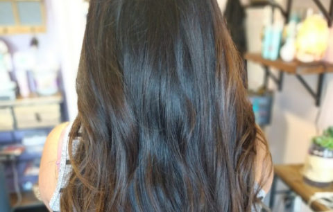 Long dark brunette hair in loose waves, back view
