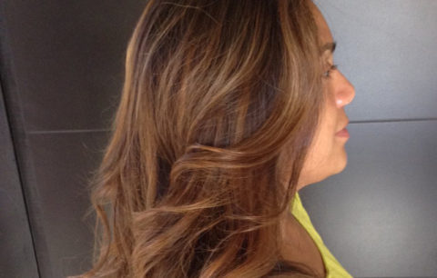 Brunette hair with warm copper and caramel dimension, side view