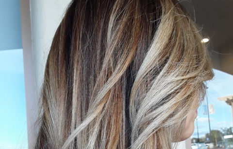 Straight hair with bold blonde pieces over a dark base